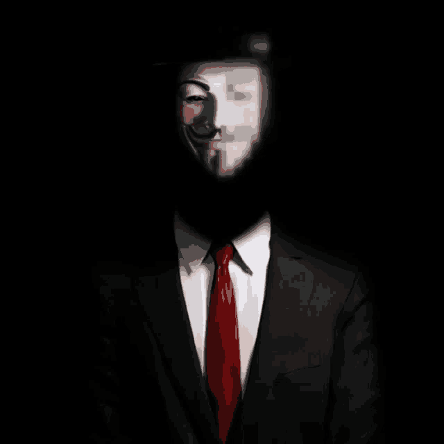 a man in a suit and red tie has a mask on his face