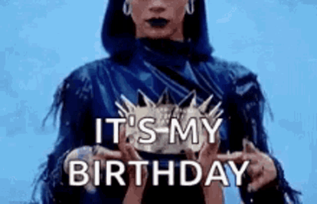 a woman in a blue dress is holding a crown in her hands and says `` it 's my birthday '' .