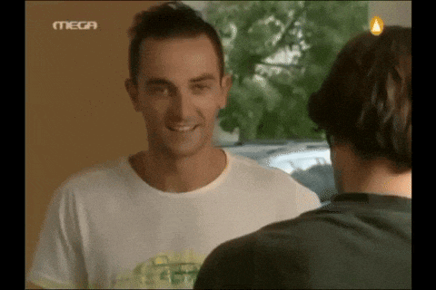 a man in a white shirt is talking to another man in a black shirt with mega written on the bottom