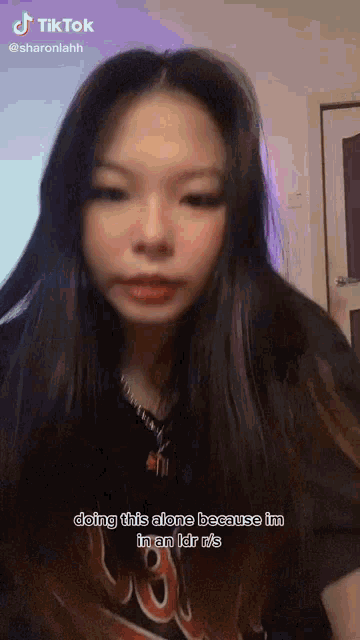 a girl with long hair is doing this alone because she is in an ldr .