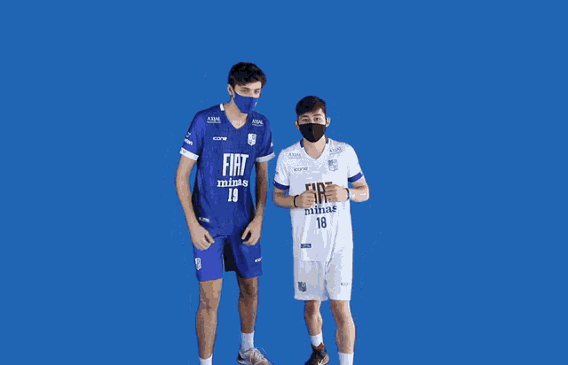 two boys wearing face masks and jerseys that say fiat minas