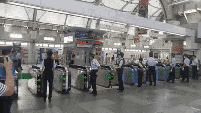 a group of people are standing in a subway station waiting to get on a train