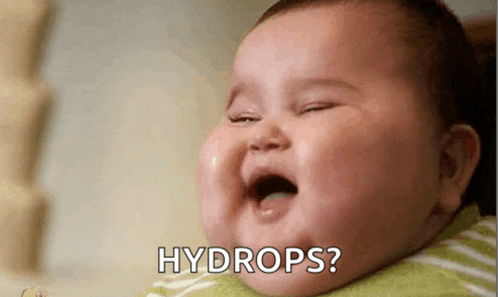 a baby is crying with its mouth open and asking for water drops .