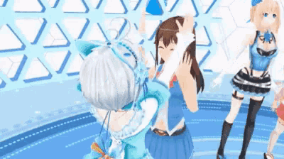 three anime girls are standing next to each other on a stage .