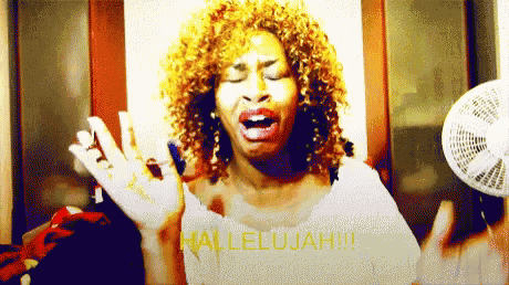 a woman with curly hair is singing hallelujah