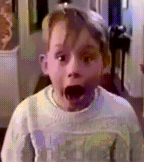 a young boy is making a surprised face with his mouth open