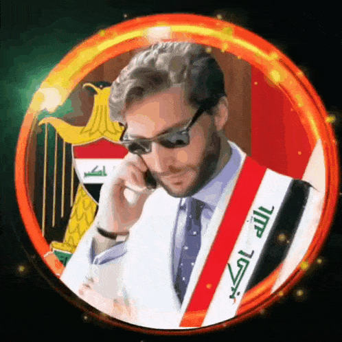 a man wearing sunglasses is talking on a cell phone while wearing a sash with arabic writing