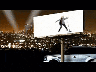 a billboard with a picture of a woman holding a microphone