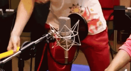 a person is standing in front of a microphone .