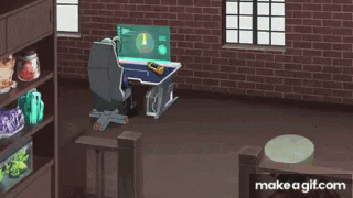 a man in a purple jacket is sitting at a table playing a game on a computer .
