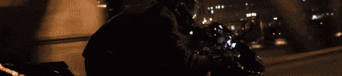 a blurry picture of a person riding a motorcycle in the dark