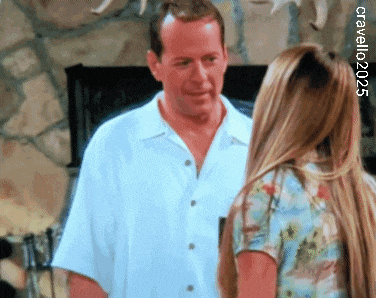 a man in a white shirt is standing next to a woman in a floral shirt with the year 2003 in the corner
