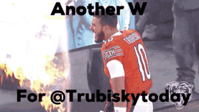 a football player with the number 10 on his jersey is standing next to a fire .