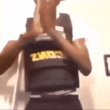 a man wearing a bullet proof vest is standing in a room .