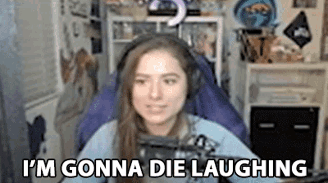 a woman wearing headphones says i 'm gonna die laughing while sitting in a chair .
