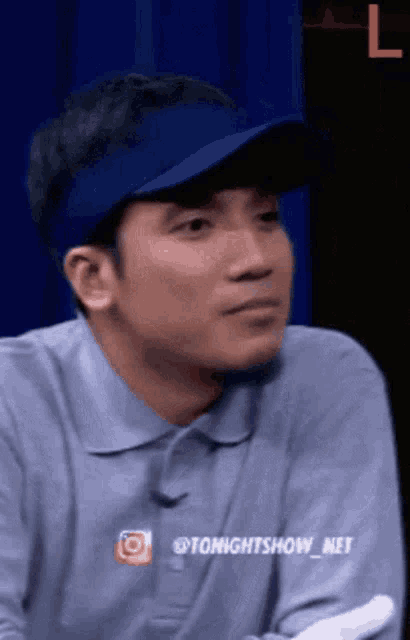 a man wearing a hat and a shirt that says tonightsshow_net
