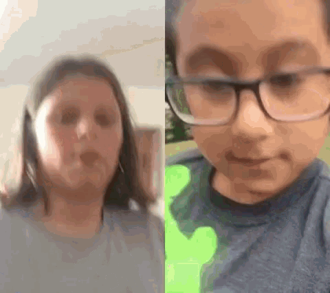 a girl and a boy are making funny faces in a video .