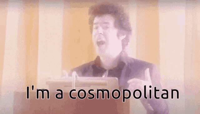 a blurry picture of a man with the words i 'm a cosmopolitan below him