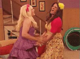 a woman in a purple dress is hugging another woman