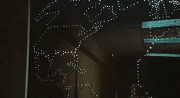 a dark room with a lot of lights on the wall and ceiling