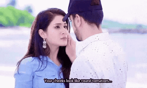 a man is touching a woman 's cheek while a woman says `` your cheeks look like round tomatoes ... ''