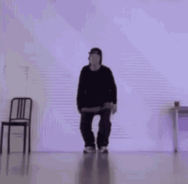 a person is standing on one leg in a dance studio .