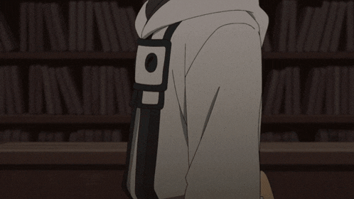 a person wearing a grey hoodie with the letter b on the sleeve