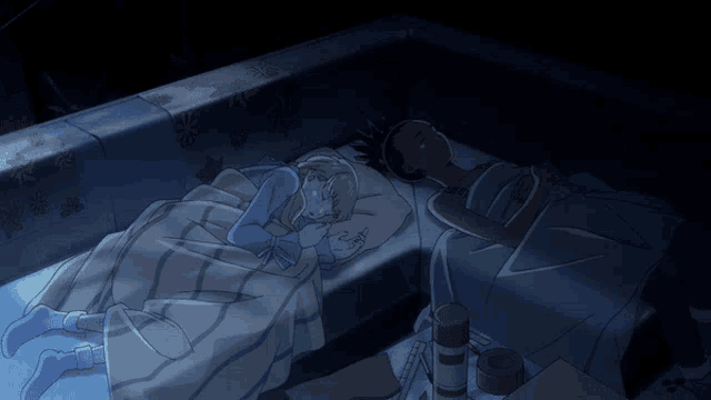 a couple of people laying on a bed with one looking at a phone
