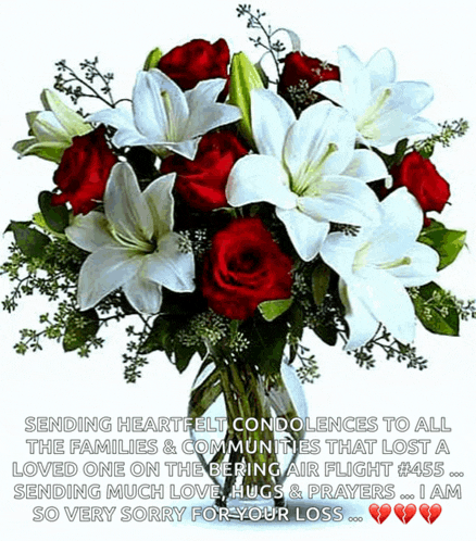 a bouquet of red and white flowers in a vase with a message