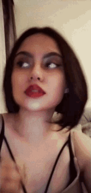 a close up of a woman with red lipstick on her lips
