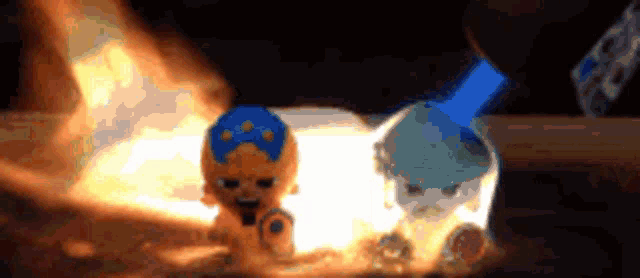 a toy with a blue hat is sitting next to a toy with a white hat