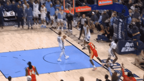 a basketball game is being played on a court with a robinhood banner in the background