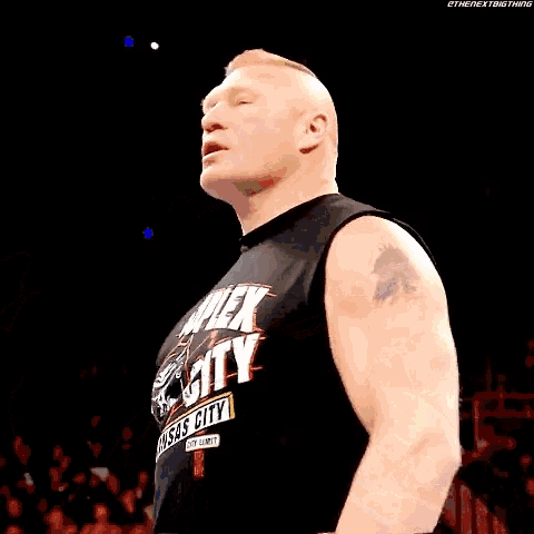 a man wearing a black shirt with the word city on it is clapping