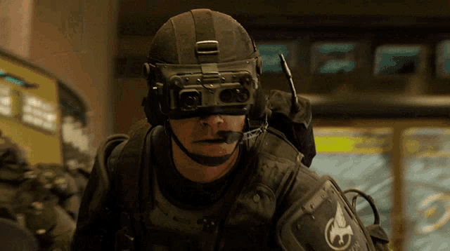 a man wearing a helmet and goggles with the letter o on it