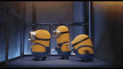 a couple of minions are standing next to each other in front of an elevator .
