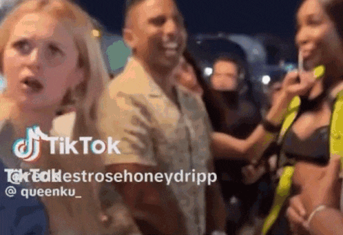 a man and a woman are standing in a crowd with a tik tok logo in the corner