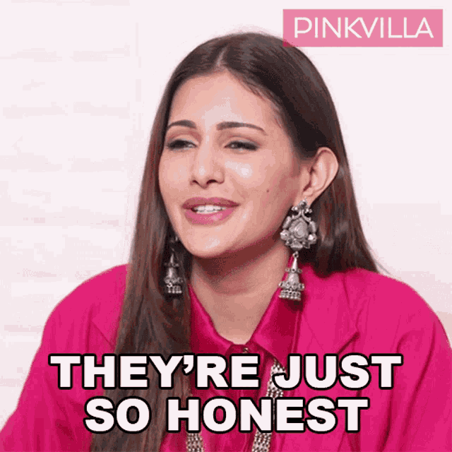 a woman wearing a pink shirt and earrings says they 're just so honest