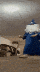 a person dressed as a wizard is using a vacuum cleaner in a garage