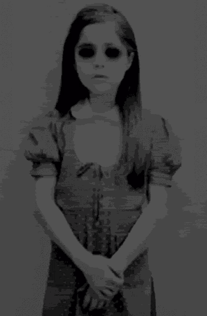 a black and white photo of a person 's face with glowing eyes .