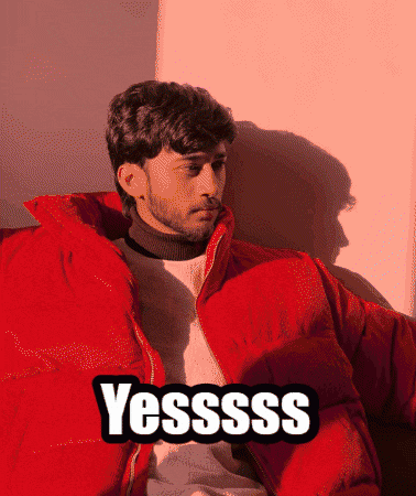 a man wearing a red jacket with the word yessss on it