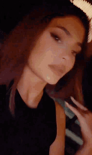 a close up of a woman 's face with a black shirt on
