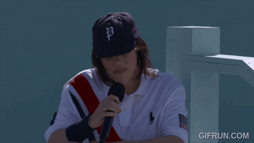 a woman wearing a hat with the letter b on it