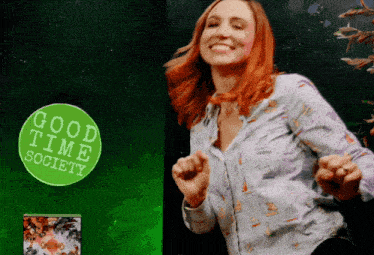a woman dancing in front of a good time society sign