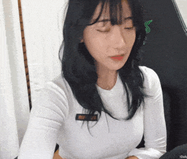 a woman wearing a white shirt with a name tag on it