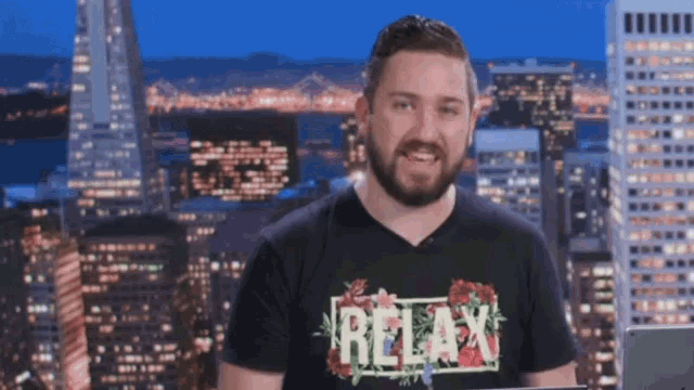 a man wearing a black shirt that says relax on it