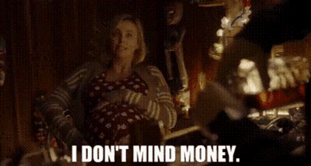 a woman sitting in a chair with the words " i don 't mind money " on the screen
