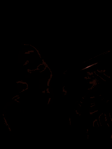 a person is sleeping with their eyes closed in a dark room