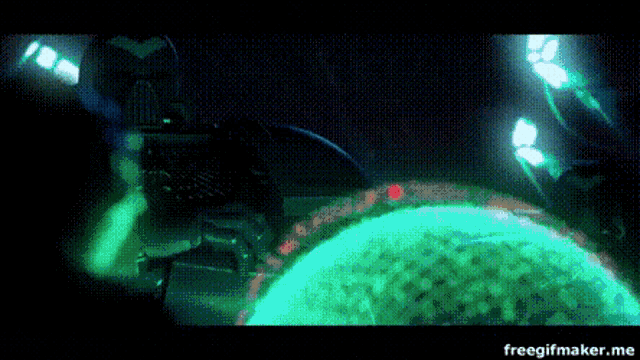 a person is standing in a dark room with a green light behind them and the words freegifmaker.me below them