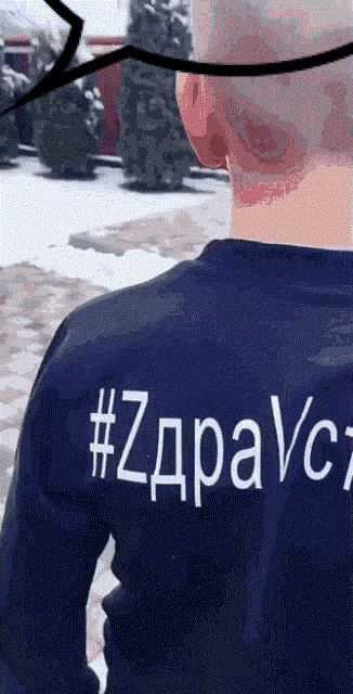 a man wearing a blue shirt that says #zdravc7