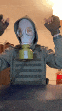 a person wearing a gas mask and a hooded vest